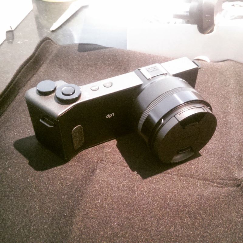 Sigma DP1 - A small camera on a black cloth.